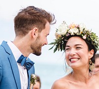 Cheerful newlyweds at beach wedding ceremony