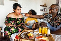 Family having breakfast in bed