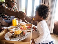 African family having breakfast in bed