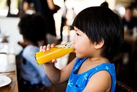 Little boy drinking orange juice