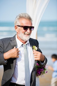 Senior groom at beach wedding