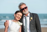 Senior couple getting married at the beach