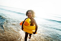 Cute toddler with duck tube on the beach