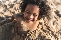 A little boy playing in the sand