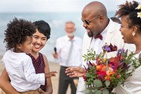 Newly weds with the guests at the beach wedding