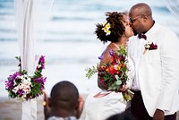 African American couple getting married at the beach