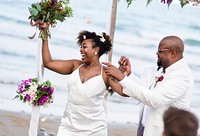 African American couple getting married at the beach