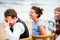 People laughing at a beach wedding