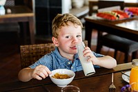 Caucasian kid having breakfast alone