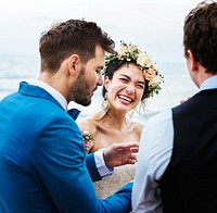 Cheerful newlyweds at beach wedding ceremony