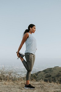 Woman stretching on a hill in LA