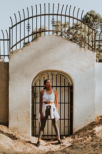 Active woman standing by a gate