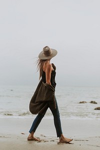 Woman walking barefoot at the beach