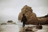 Woman walking barefoot at a beach