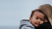 Little boy being carried by his mom