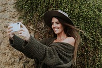 A woman taking photos with her phone