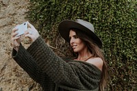 A woman taking photos with her phone