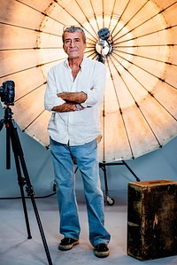 Director standing in front of a reflective umbrella in a studio
