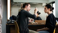 Makeup artist applying makeup onto model