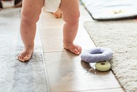 Closeup of baby&#39;s legs while standing