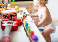 Baby in a diaper in a play room