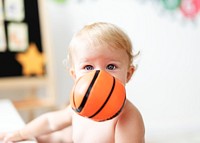 Baby playing with a basketball toy