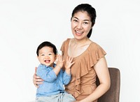 Mom and her cheerful baby sitting on a chair