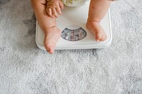Closeup of a baby&#39;s legs on a weighing scale