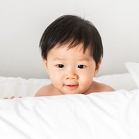 Closeup of a baby playing with a pillow
