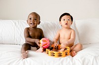 Babies playing on the bed