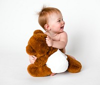 Baby hugging her teddy bear