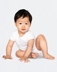 Baby sitting on the floor in a studio