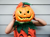 Little kid with Halloween pumpkin