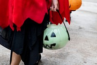 Closeup of kid holding a Halloween bucket