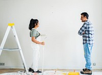 Couple painting the walls in their new apartment