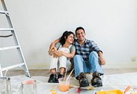 Couple resting after painting the room
