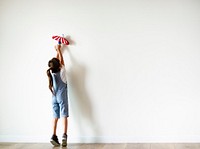 Young girl playing with a toy plane