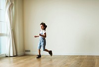 Young girl playing in an empty room