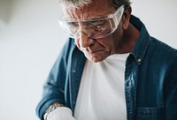 Man wearing safety glasses while renovating the house