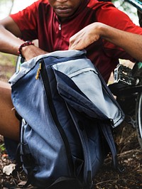 Cyclist getting stuff from backpack