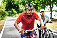 Cyclist couple riding together in a park