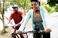 Cyclist couple riding together in a park