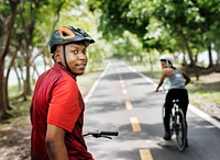 Cyclist couple riding bikes in a park