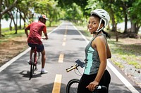 Cyclist couple riding bikes in a park