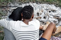 Couple sitting by the bonfire ashes