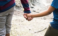 Cheerful couple holding hands on a trek