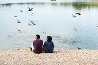 Couple sitting by the lake
