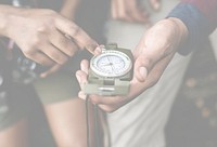 Couple using compass in a forest