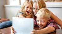Blonde mom and kids making a video call on a tablet