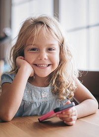 Portrait of a little girl with her phone in her hand